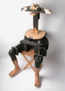 Wooden modelling frame of a human torso painted black in areas with detailed, jointed legs. Made by Charles Paget Wade to support a suit of samurai armour when on display. 
